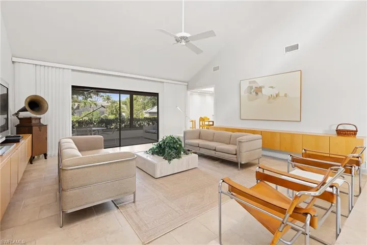 Tiled living room with lanai and lake view