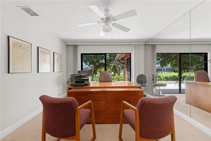 Office space with ceiling fan and light colored carpet