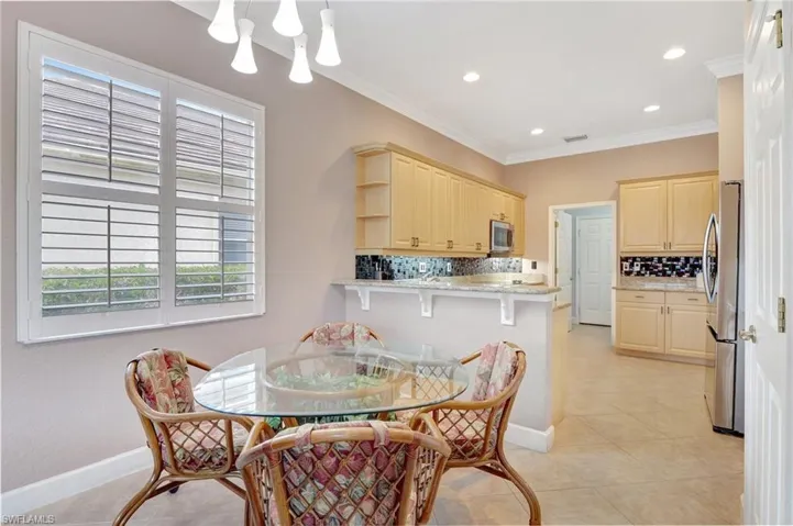Dining space featuring recessed lighting, crown molding, baseboards, and light tile patterned floors