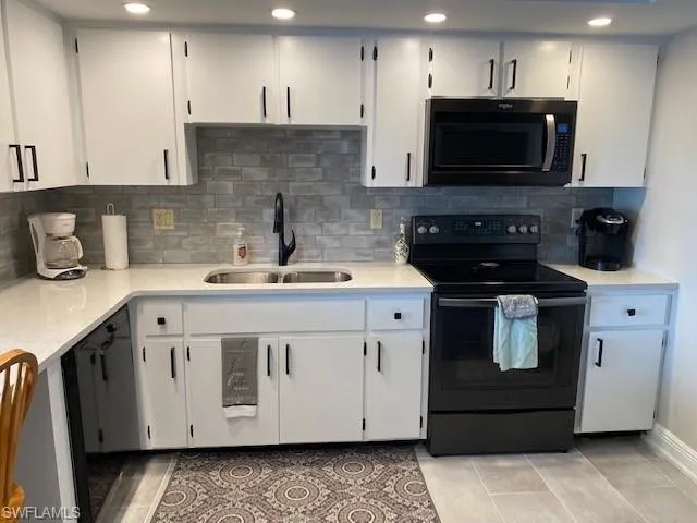 Crisp and clean kitchen with full appliances-Side by side refrigerator with ice maker, smooth top range, microwave and dishwasher.