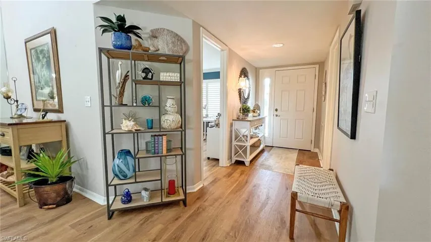Doorway with hardwood / wood-style floors