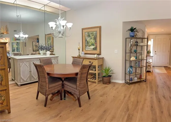 Dining area with light hardwood / wood-style flooring and a chandelier