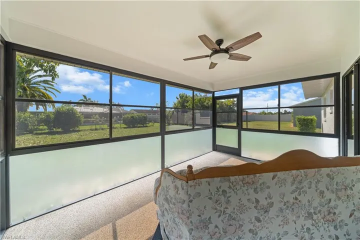 Sunroom featuring ceiling fan