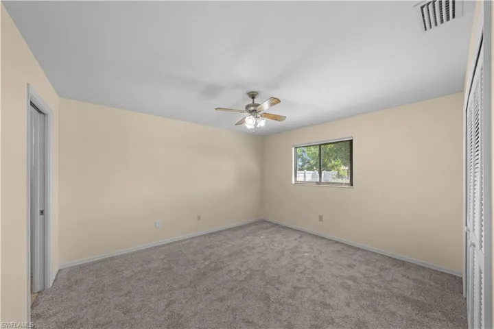 Unfurnished bedroom featuring a closet, carpet flooring, and ceiling fan