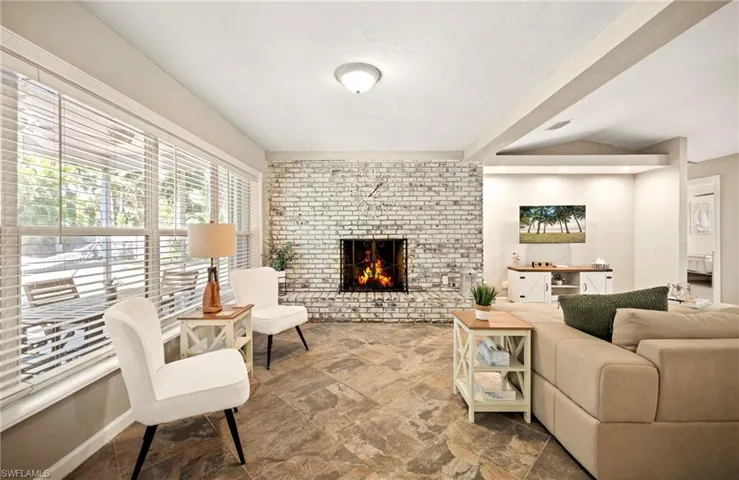 Living area featuring a fireplace and stone finish floors