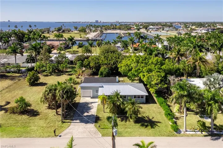 Aerial view of residential area featuring a nearby body of water