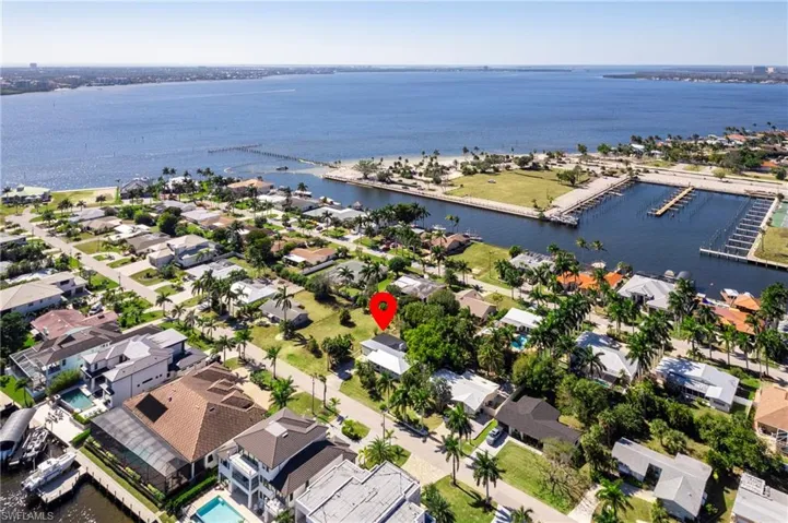 View of property location with a large body of water and nearby suburban area