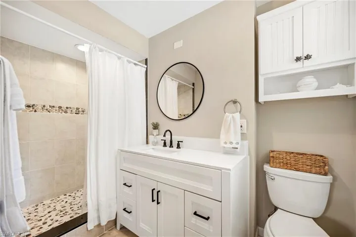 Bathroom with vanity and a shower stall