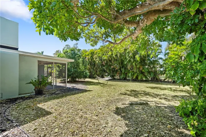 View of green lawn featuring a patio