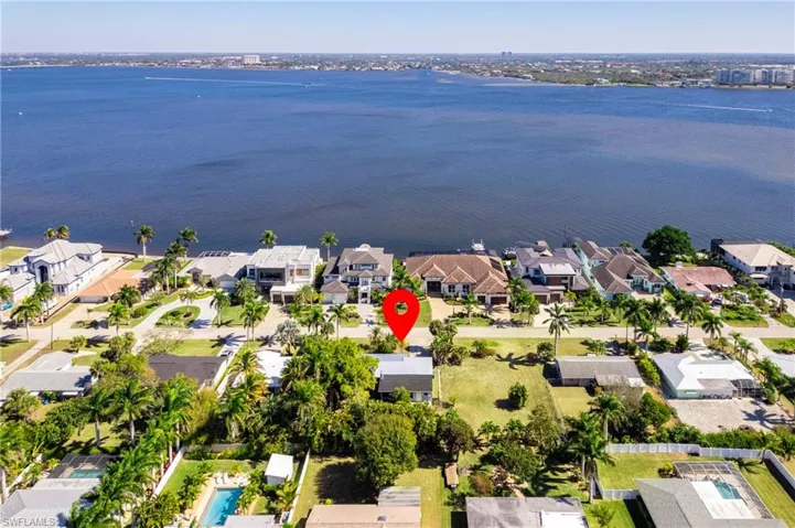 Aerial view of property and surrounding area with nearby suburban area