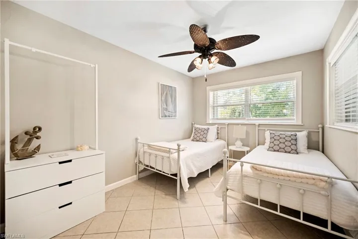 Bedroom with a ceiling fan and light tile patterned floors