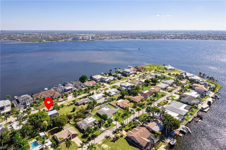 Aerial overview of property's location with a nearby body of water and nearby suburban area