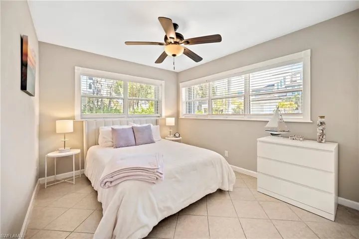 Bedroom with a ceiling fan and light tile patterned floors