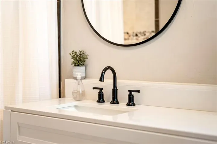 Bathroom view of vanity and a shower with shower curtain