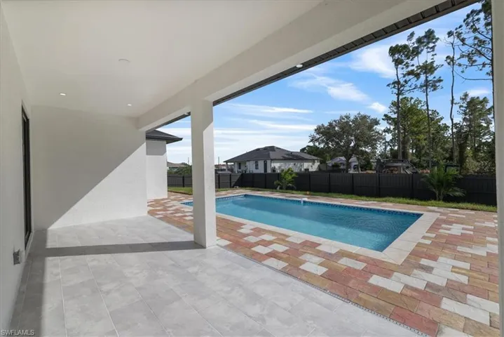 View of swimming pool with a patio and a fenced backyard