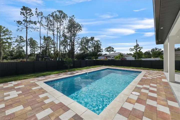 View of swimming pool featuring a patio and a fenced backyard