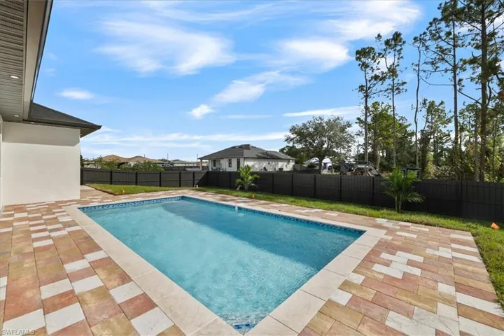 View of swimming pool featuring a patio and a fenced backyard