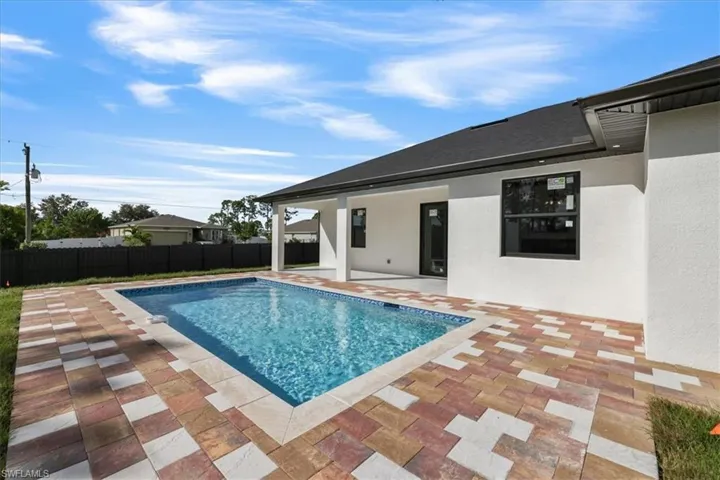View of pool with a patio area and a fenced backyard