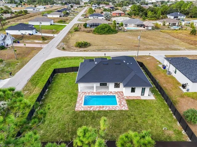 Aerial perspective of suburban area featuring a pool area