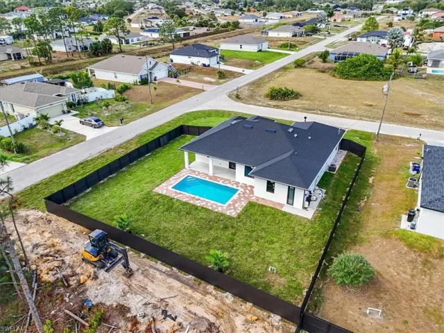 Aerial perspective of suburban area with a pool
