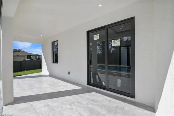 View of exterior entry featuring a patio and stucco siding