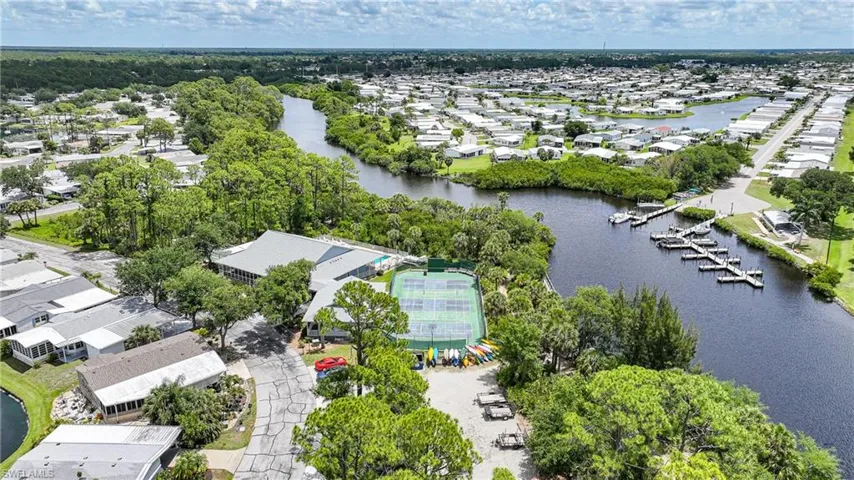 Aerial view showcasing a waterfront community with extensive green spaces