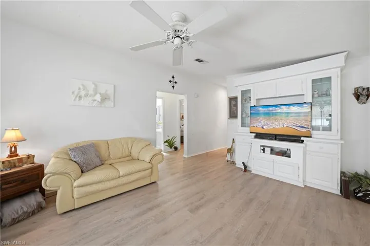 Light wood-finish flooring complements the neutral wall tones