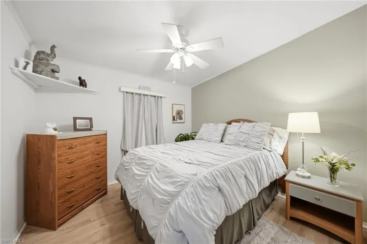 Bedroom with wood-finish flooring and a vaulted ceiling