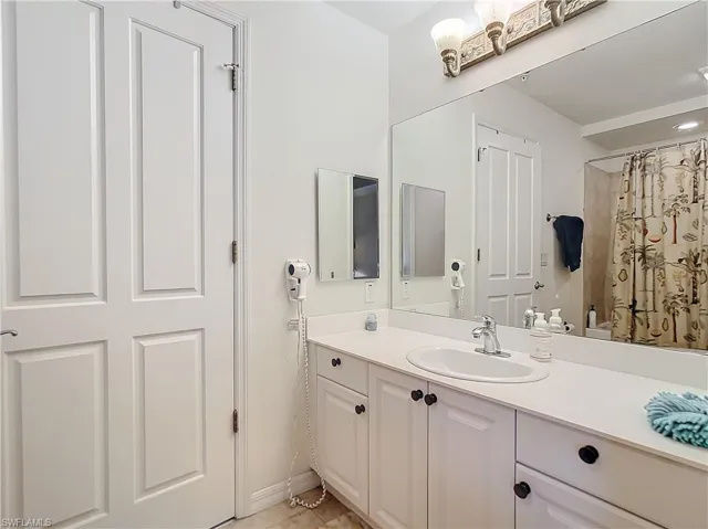 Jack & Jill Bathroom with vanity and a tub shower combo shower with shower curtain