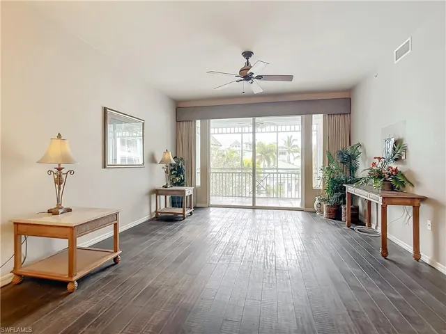 Sitting room with ceiling fan and dark hardwood / wood-style flooring