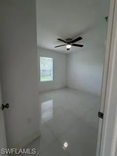 White tile flooring, single window, and a ceiling fan with integrated lighting