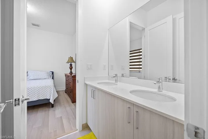 Bathroom featuring hardwood / wood-style floors and double vanity
