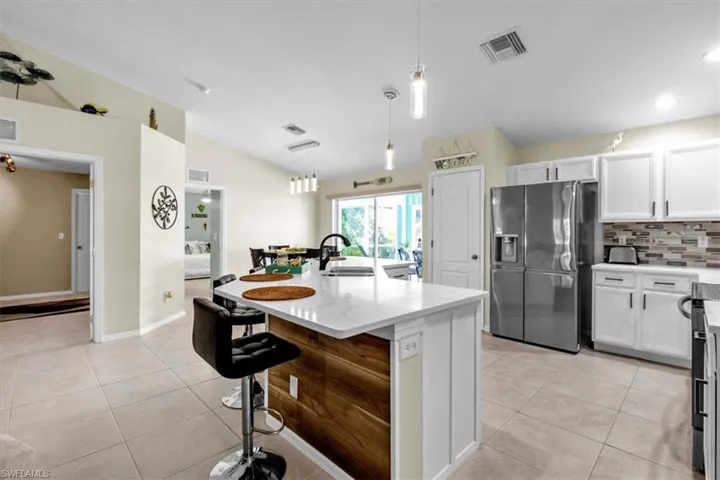Kitchen island with a white countertop and wood-finish paneling