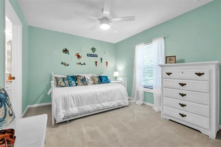 Recessed lighting, ceiling fan, window with blinds and sheer curtains, carpeted flooring, and built-in cabinetry