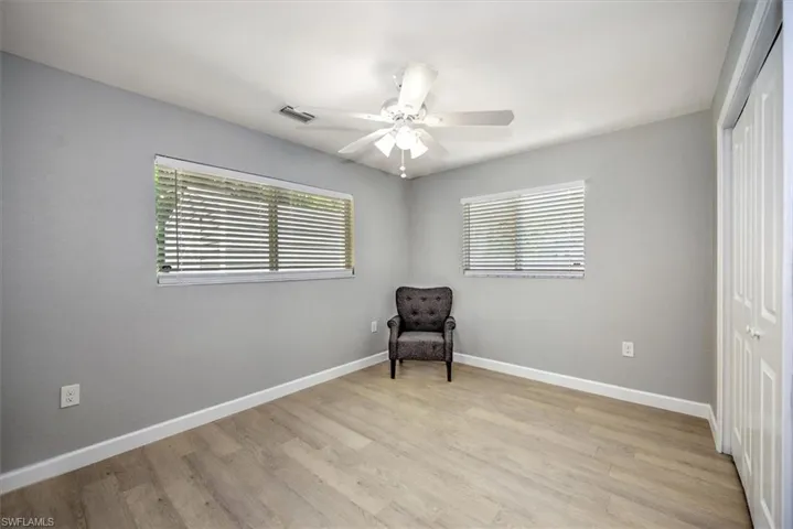Unfurnished room featuring plenty of natural light, baseboards, visible vents, and light wood-style floors