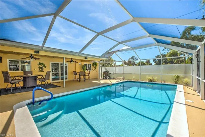View of pool with a ceiling fan, a lanai, a patio area, and a fenced in pool
