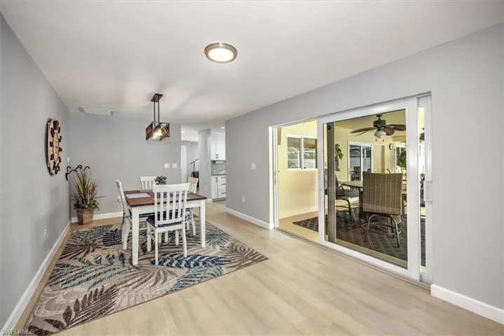 Dining room with baseboards, visible vents, light wood-style flooring, and a ceiling fan