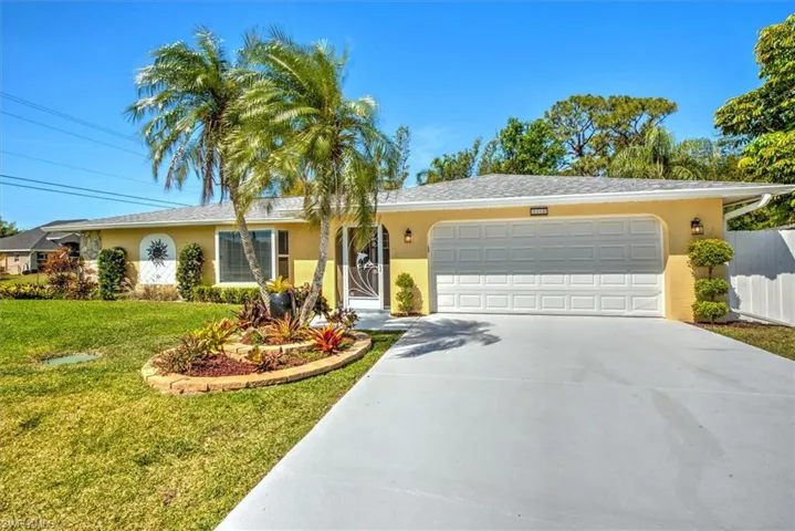 Ranch-style house with concrete driveway, stucco siding, fence, an attached garage, and a front yard