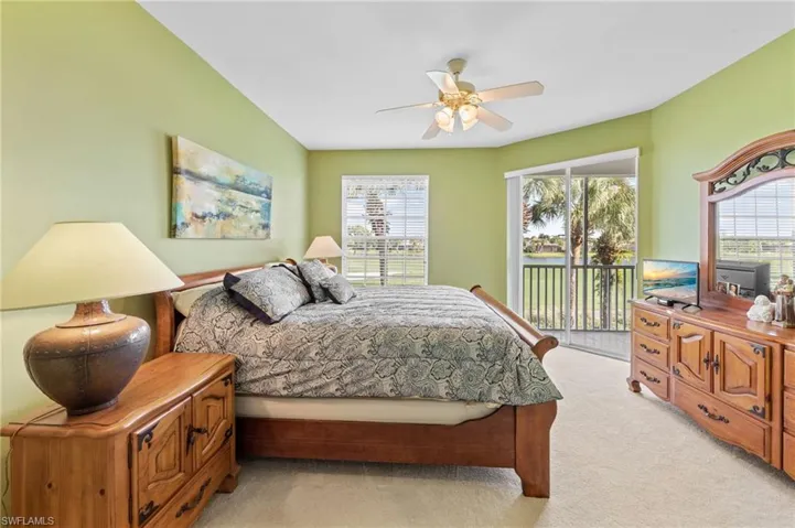 Bedroom featuring light carpet, access to outside, and ceiling fan