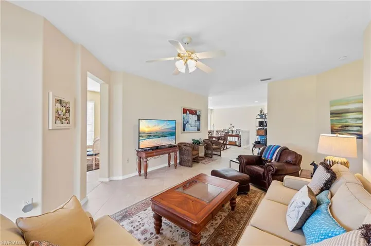 Living area featuring light tile patterned flooring and a ceiling fan