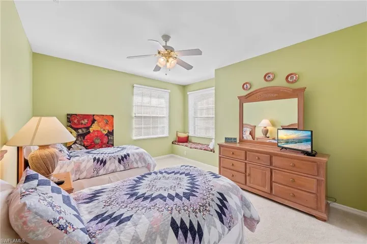 Bedroom featuring light colored carpet and a ceiling fan