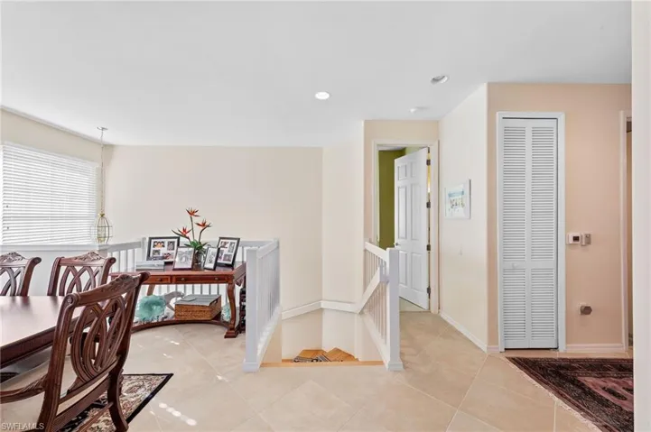 Dining space featuring light tile patterned floors and recessed lighting
