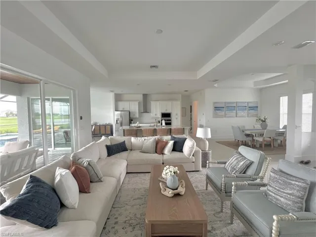 Living room featuring a raised ceiling