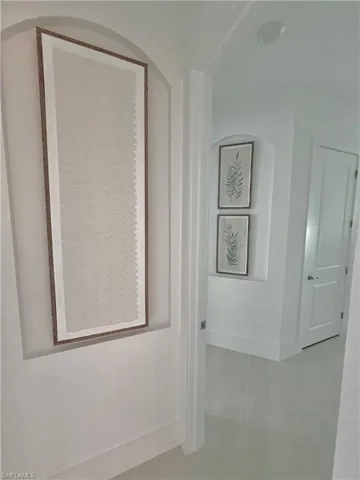 Corridor with light tile patterned floors