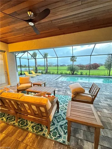 Beautifully finished covered lanai with furniture and pool