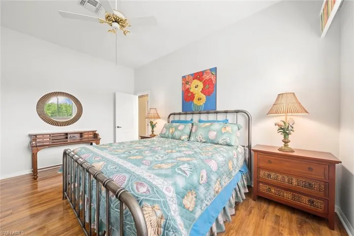 Bedroom with wood finished floors, baseboards, and a ceiling fan