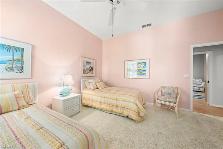 Bedroom featuring carpet floors, baseboards, and a ceiling fan