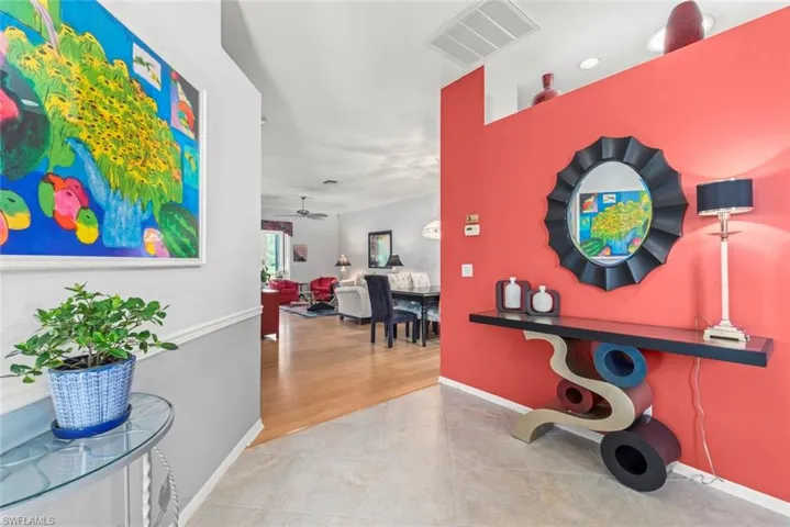 Hall featuring tile patterned flooring and baseboards