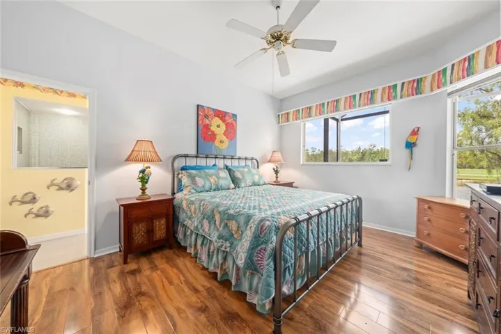 Bedroom with baseboards, wood finished floors, and a ceiling fan