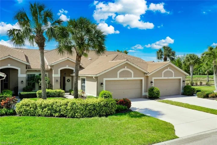View of front of home featuring stucco siding, a front yard, driveway, and an attached garage